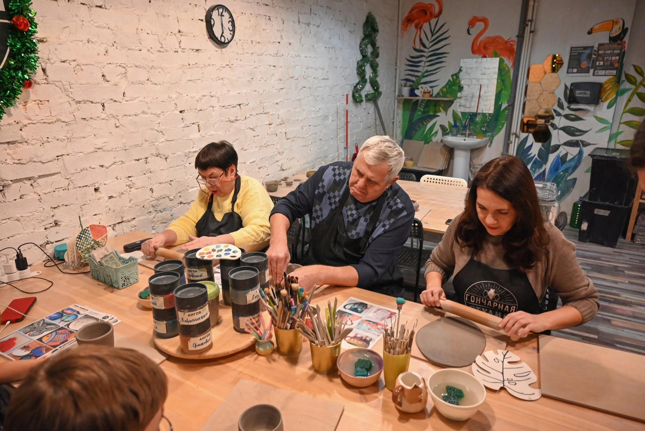 Pottery Deep Ellum instructor demonstrating clay shaping methods
   