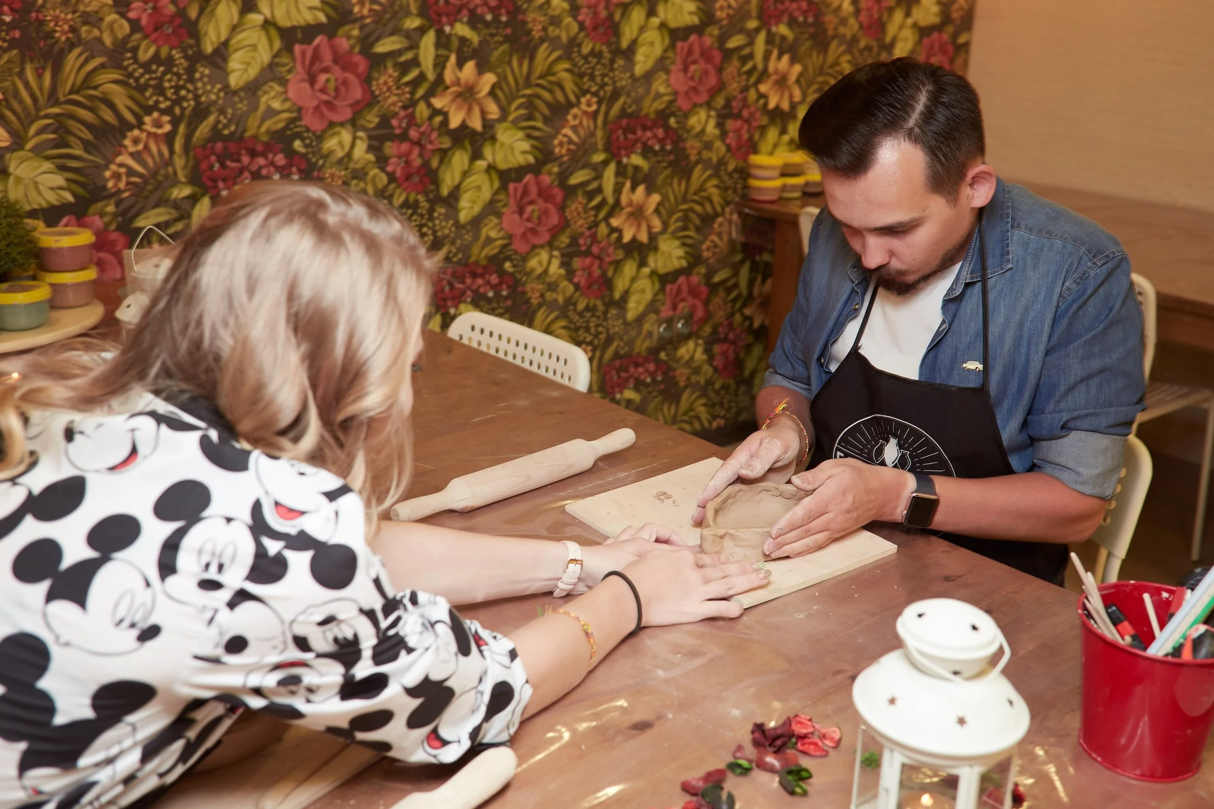 Pottery classes Bryan Place instructor guiding students step by step   