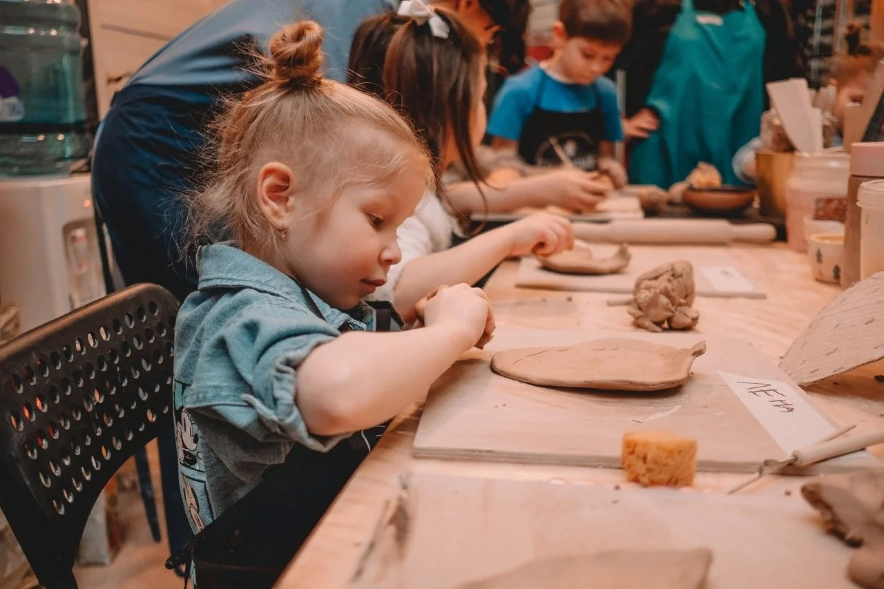 Pottery classes Peak’s Suburban Addition kids molding clay  
