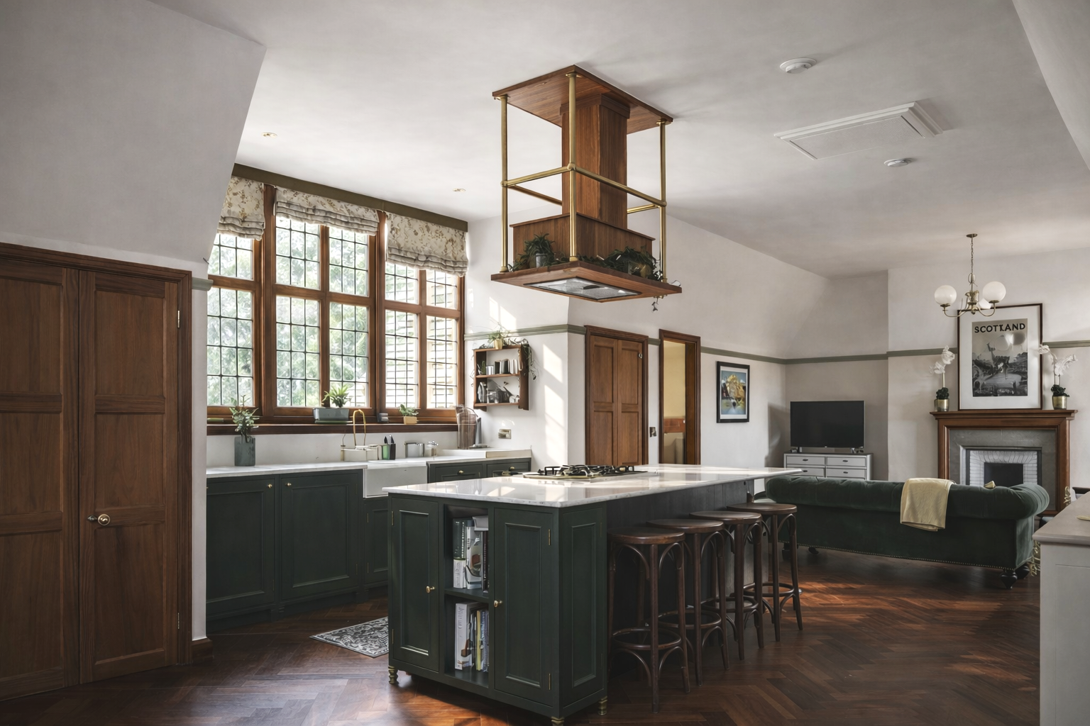 A spacious kitchen and living room with large windows, wooden cabinets, a kitchen island with stools, and a fireplace with a TV above. There is a hanging wooden shelf and a framed picture on the wall.