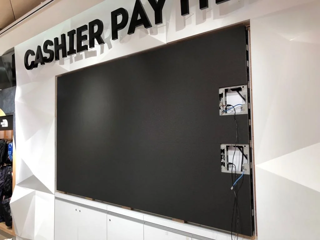 A black digital display panel missing from a frame at a checkout area, with the words "CASHIER PAYMENT" visible above.
