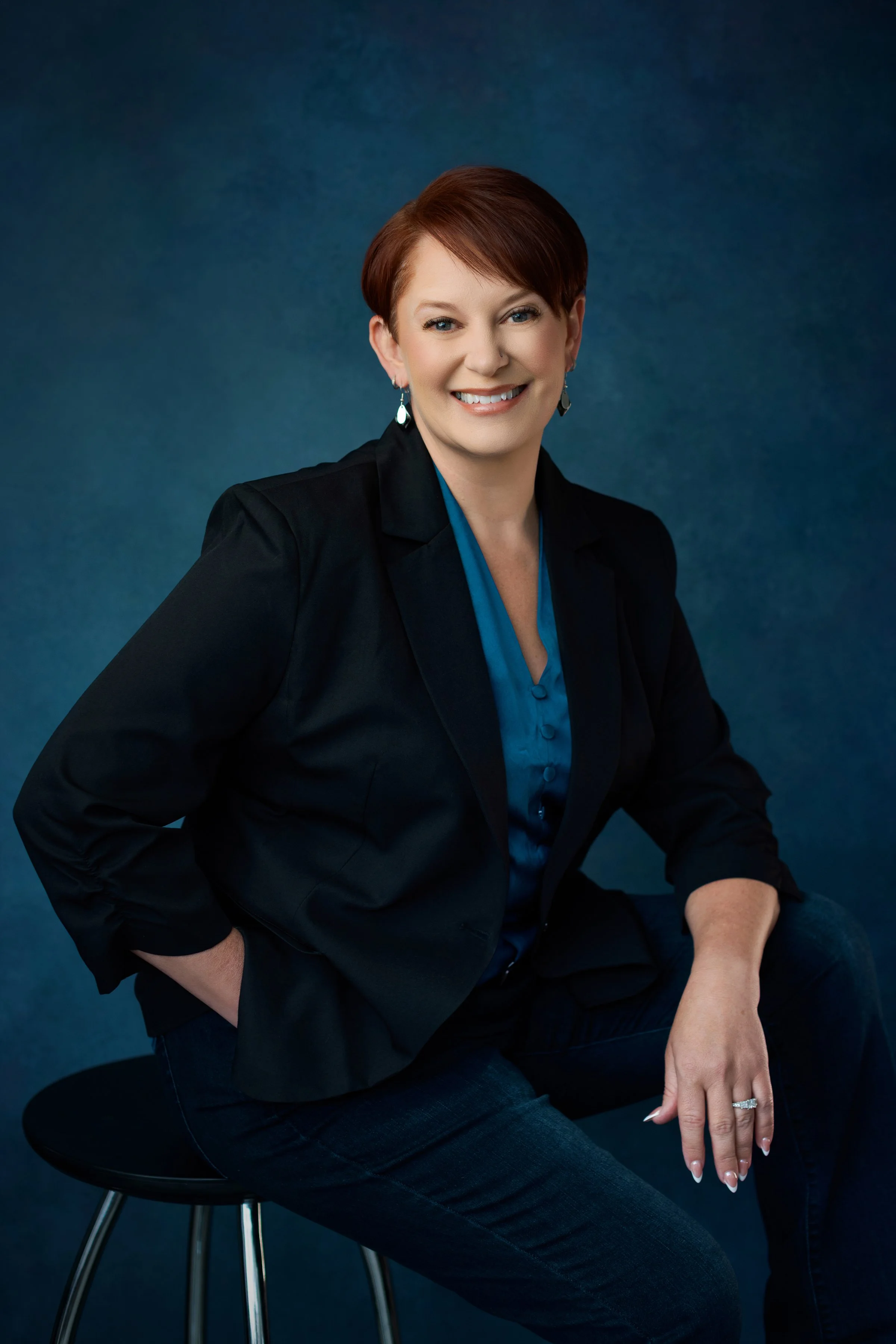 Headshot of Michelle Nielson, a white woman with short red hair who is smiling at the camera