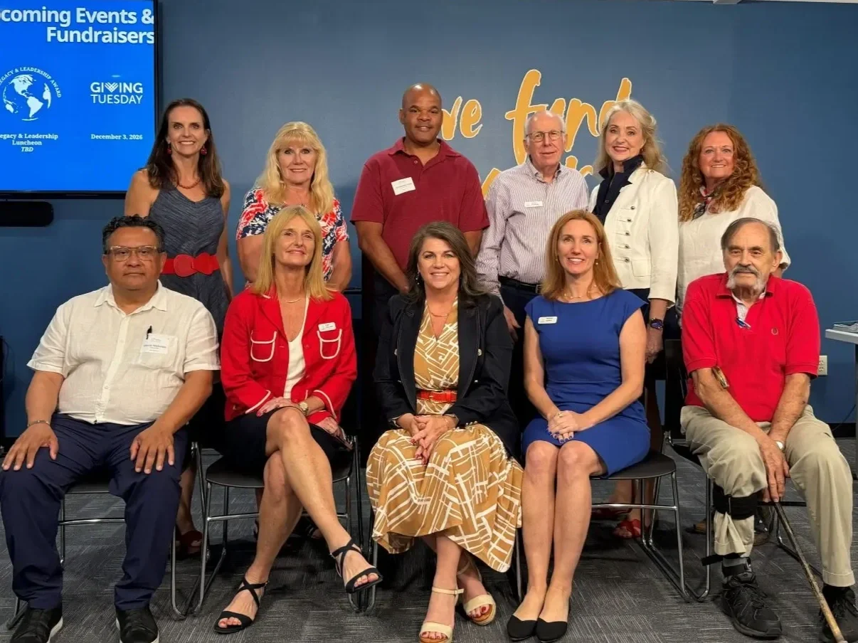 Modern Widows Club Board and Ambassador Council 2026. The front row of 5 people sit in chairs and 6 people stand behind them.