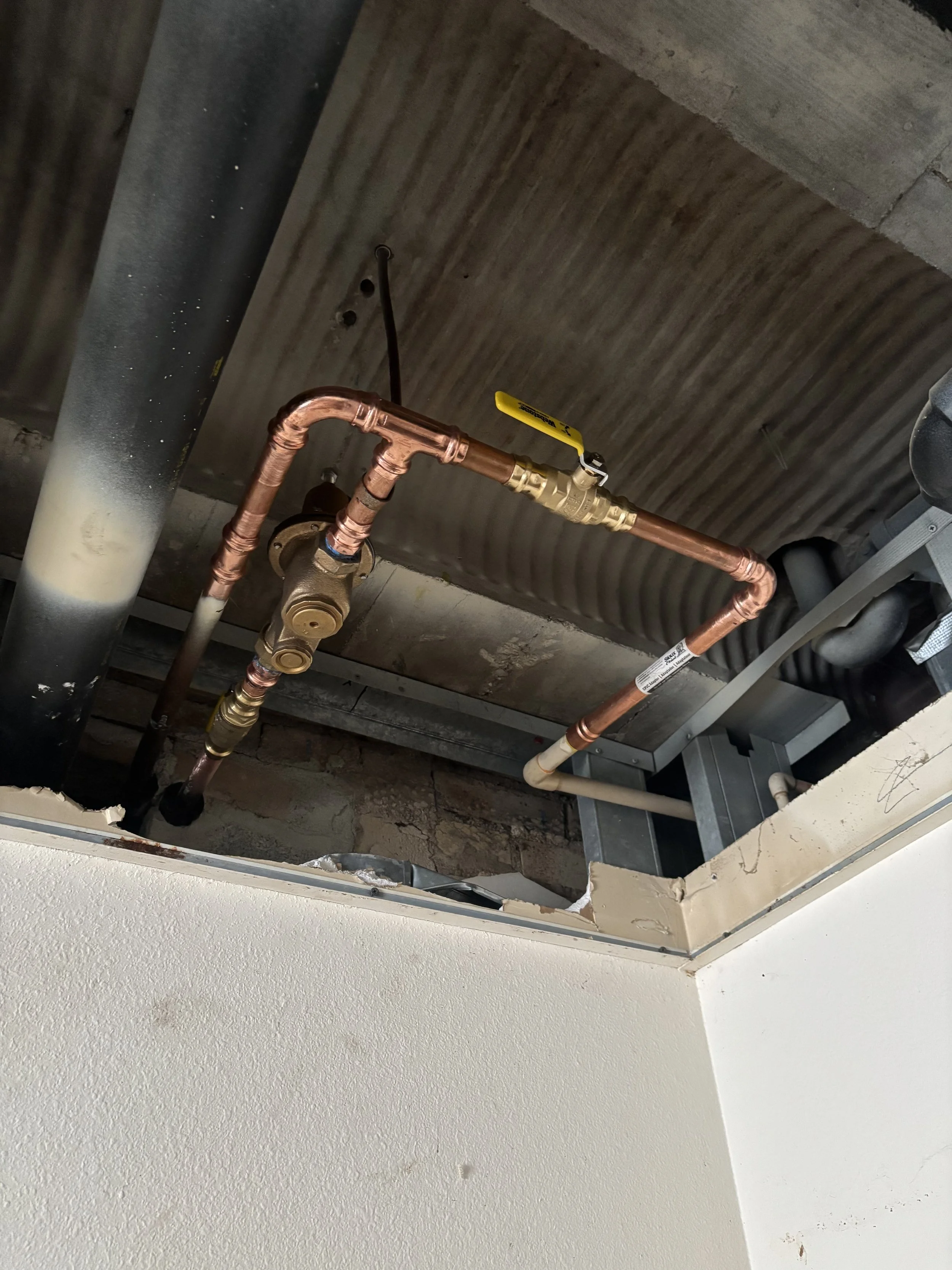 Commercial PRV replacement by RonJon Plumbing in Hilliard, Ohio, featuring new pressure-reducing valve with copper tie-ins to existing CPVC and new shutoff valve installation.