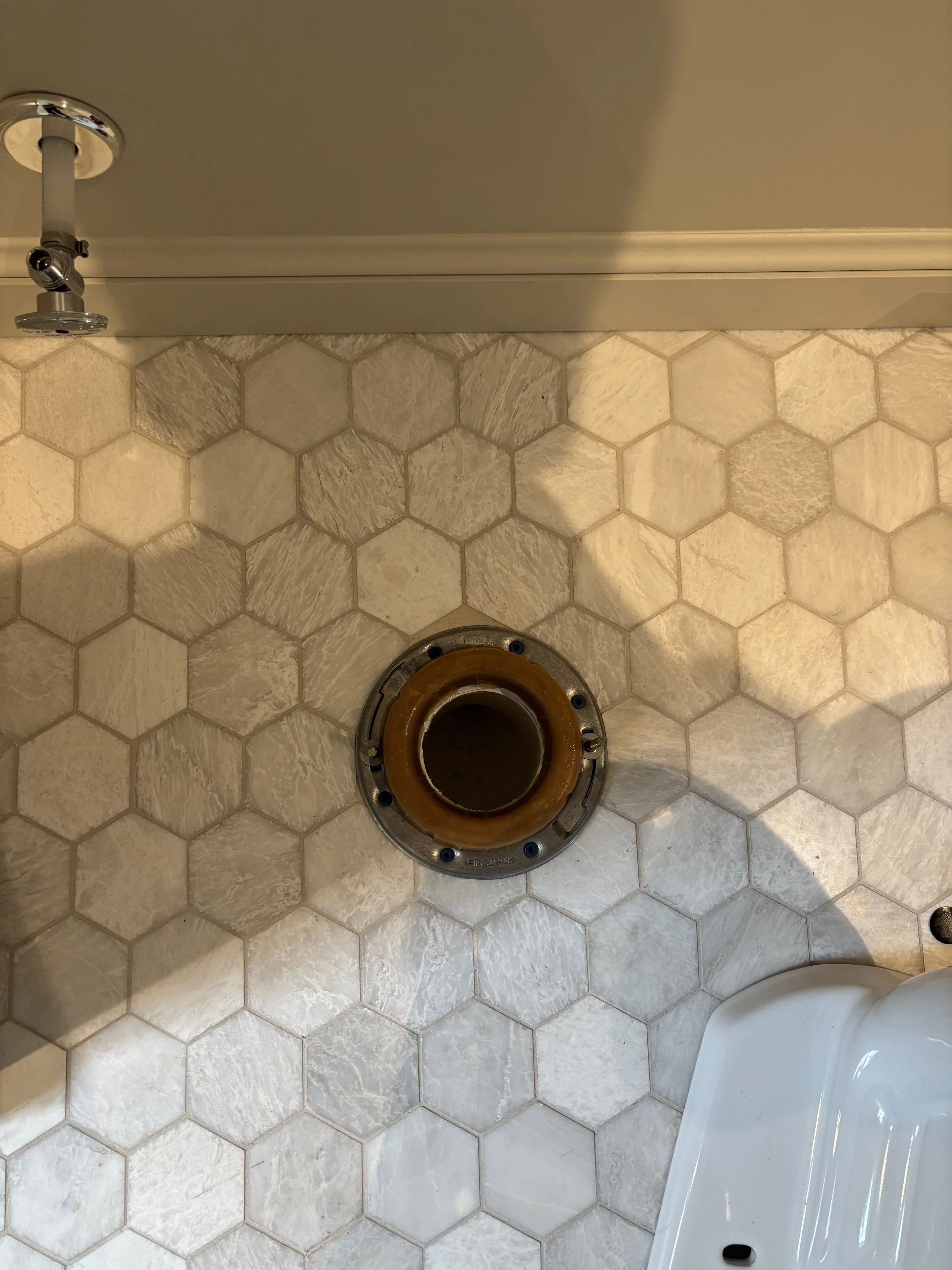 Toilet flange replacement by RonJon Plumbing in Sunbury, Ohio, featuring new wax ring, shutoff valve, chrome escutcheon, and supply line ready for toilet installation.