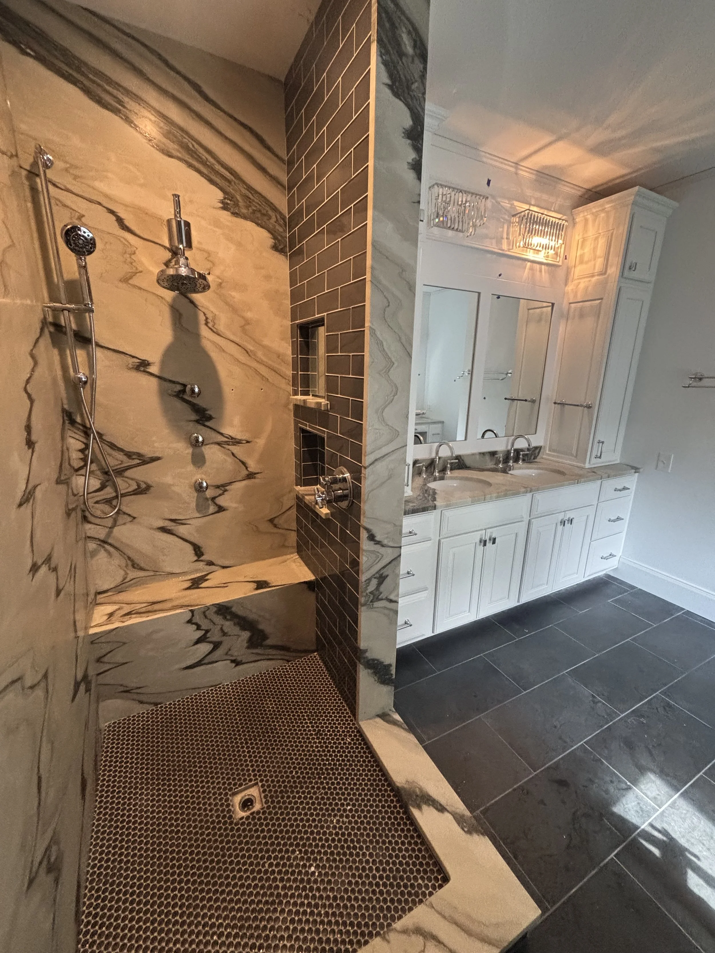 Custom walk-in shower plumbing installation with rainfall shower head, handheld shower and body sprays by RonJon Plumbing in Columbus, Ohio.