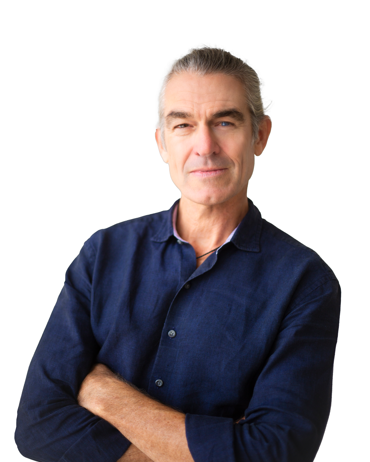 A middle-aged man with gray hair and blue eyes, wearing a dark blue button-up shirt, standing with arms crossed against a plain background.