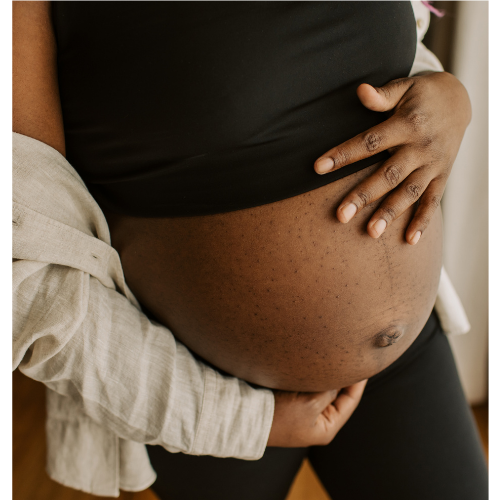 a pregnant woman holding her belly