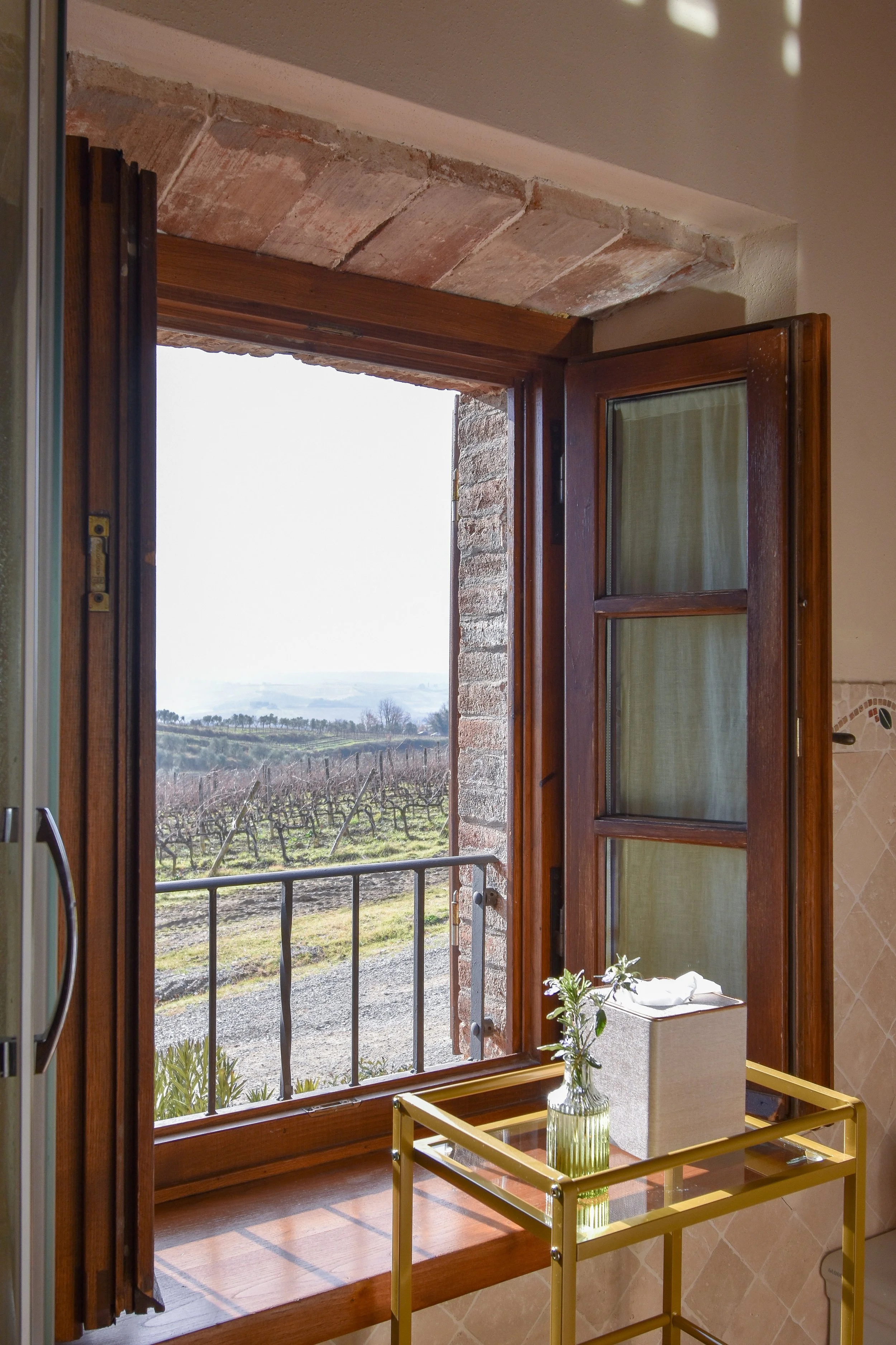 The villa offers an enchanting retreat surrounded by breathtaking views of vineyards and olive groves.