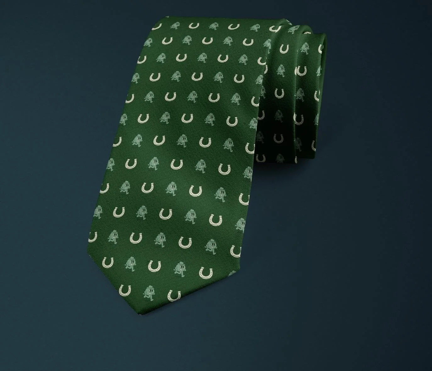 Introducing design number 1 of our collab with @oliverjorgties 

The Lucky Post

Set against a deep racing-green silk, The Lucky Post features The Paddock Preview Logo paired with classic horseshoe motifs in a balanced, repeating pattern. The contras