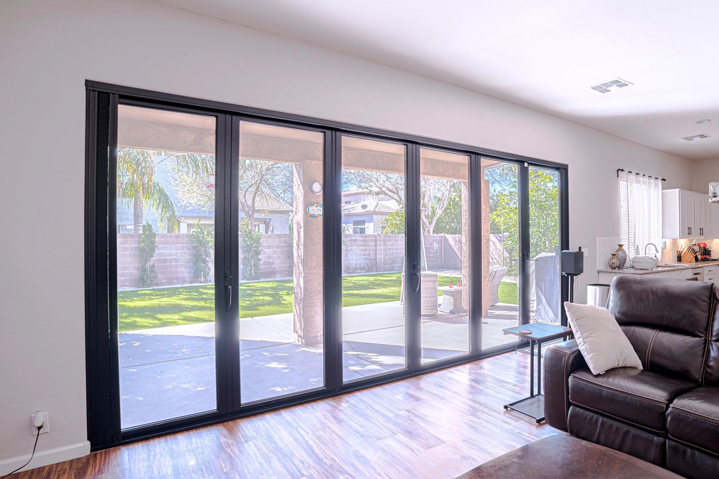 Black 6- Panel- Aluminum Bifolding Door in Arizona With Interior Screen To Prevent Bugs-Header Replacement-Full Service Bifold Door Replacement With Stucco-Drywall-Paint-and Header Replacement
