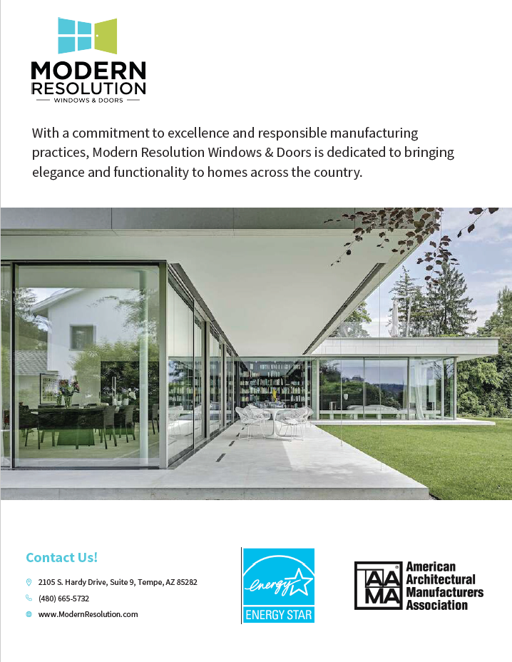 Modern house with large glass windows and sliding doors, surrounded by green lawn and trees, with a covered patio area.