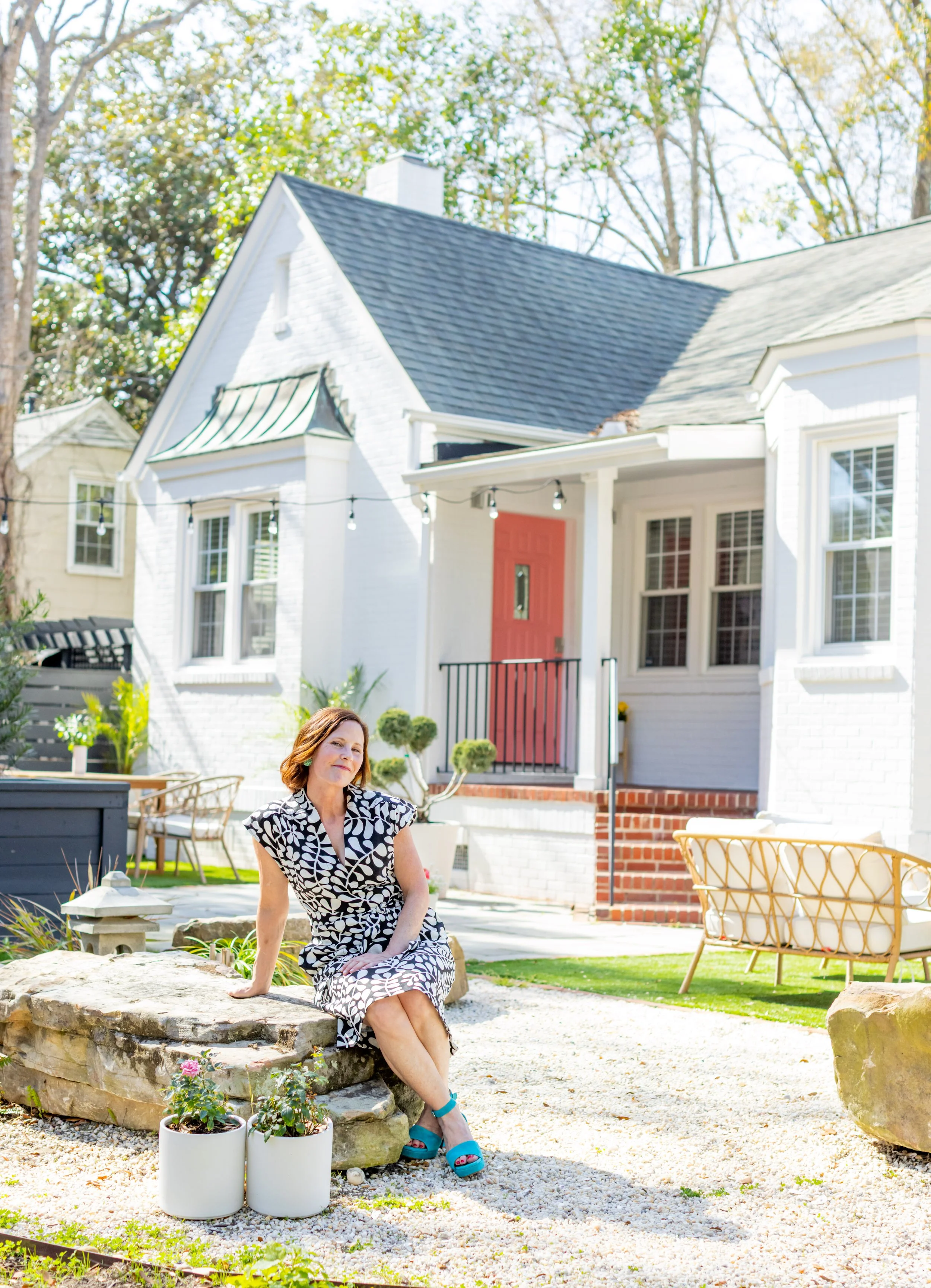 Ann Zalla relaxing outdoors on a Charleston porch, reflecting the welcoming spirit of The Southern Zen.