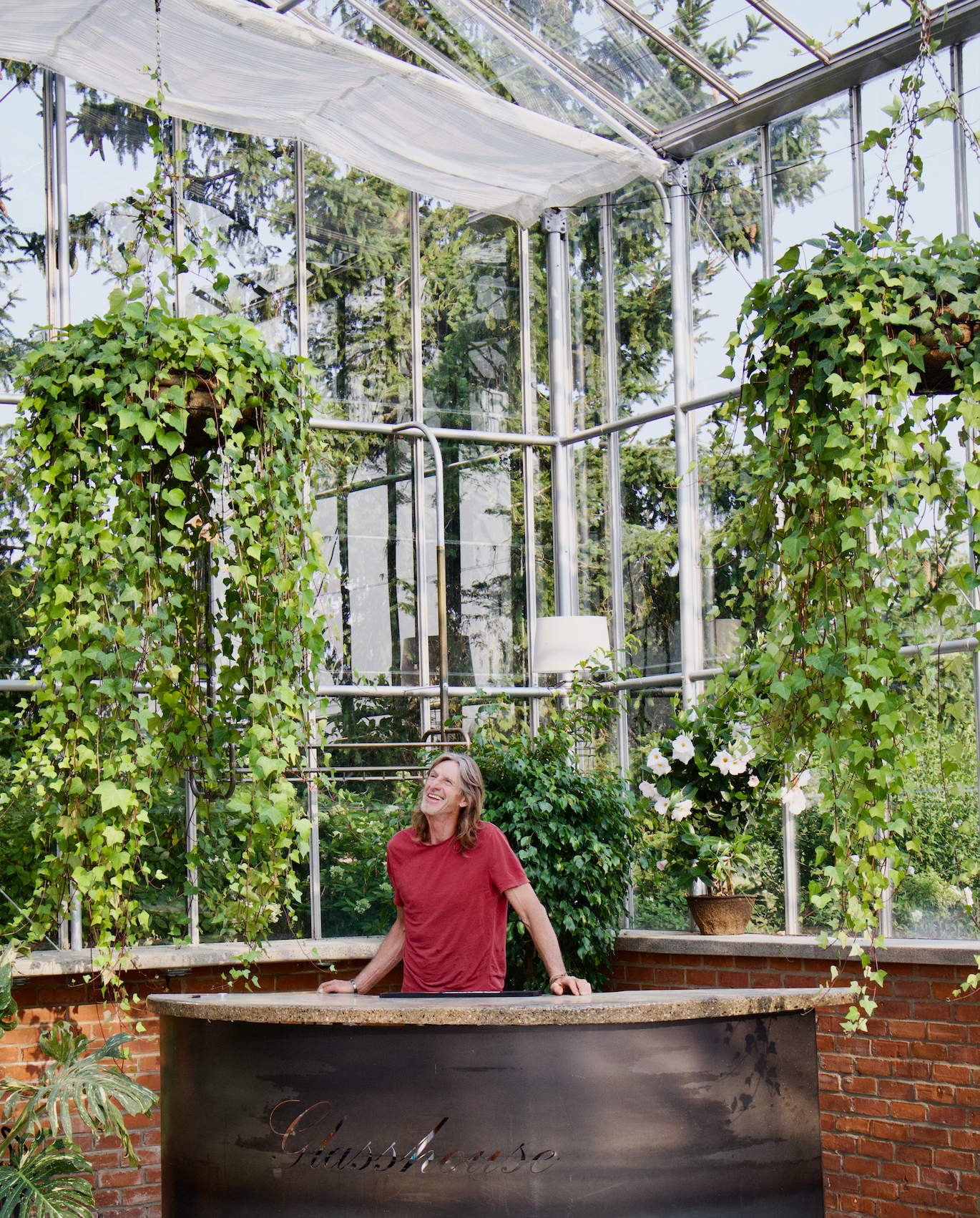 A man smiling in a greenhouse