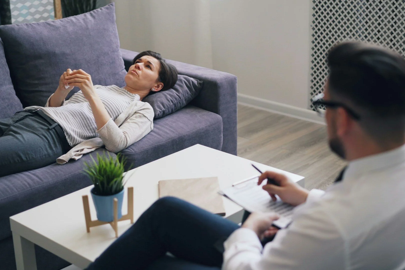 a-man-sitting-on-a-couch-next-to-a-woman