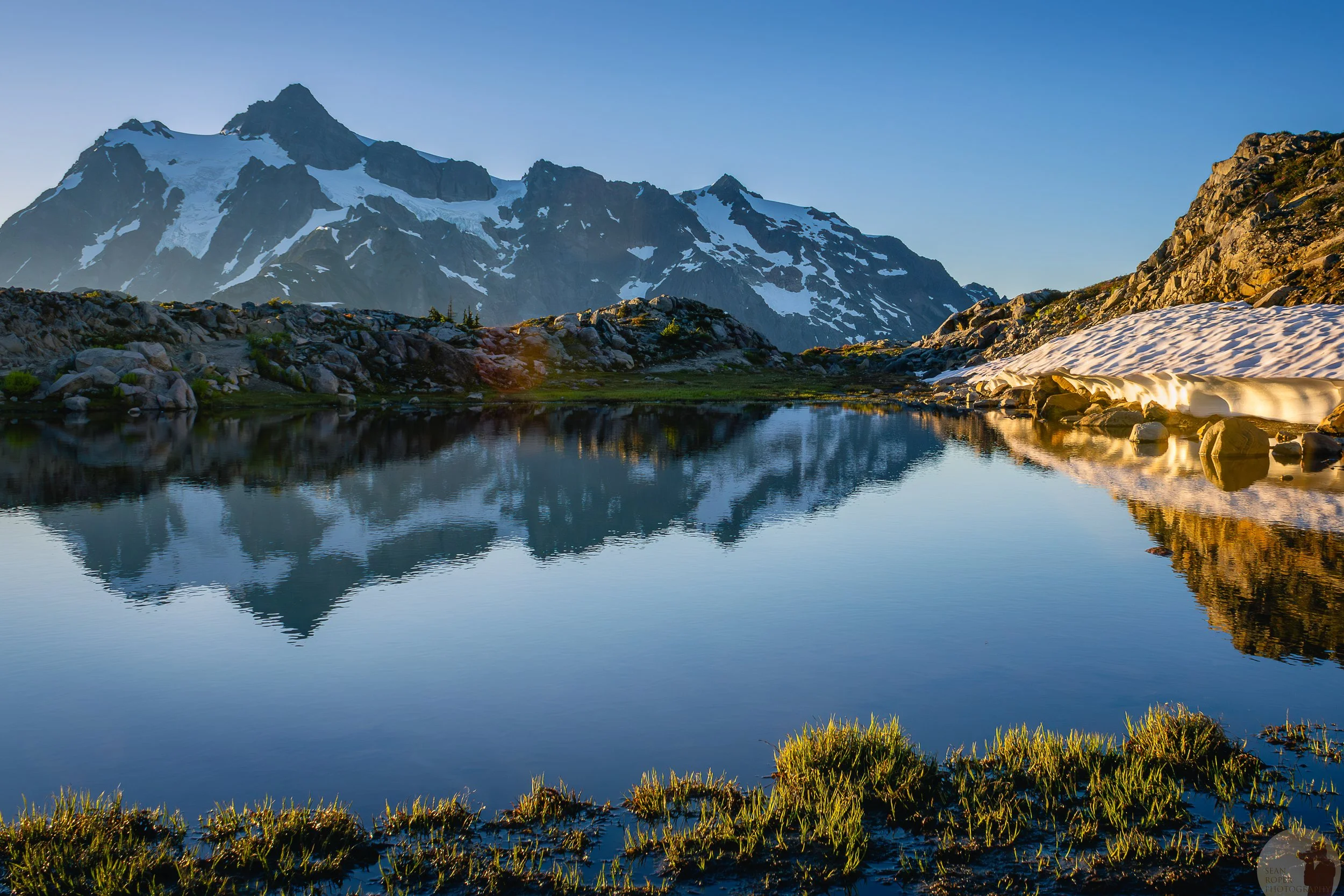 An alpine tarn reflects Mount Shuksan