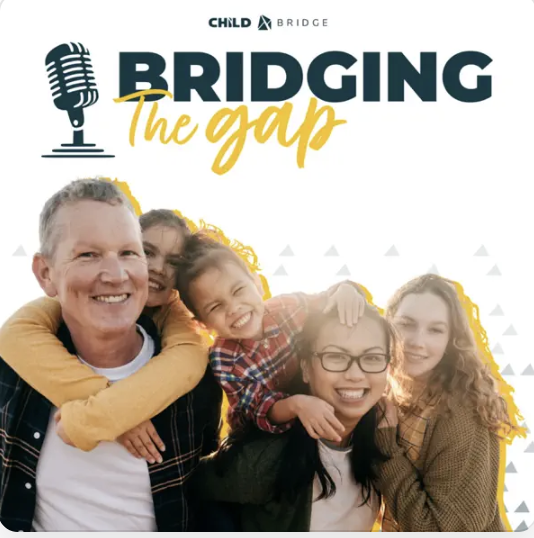 dad and mom with their three daughters hugging them