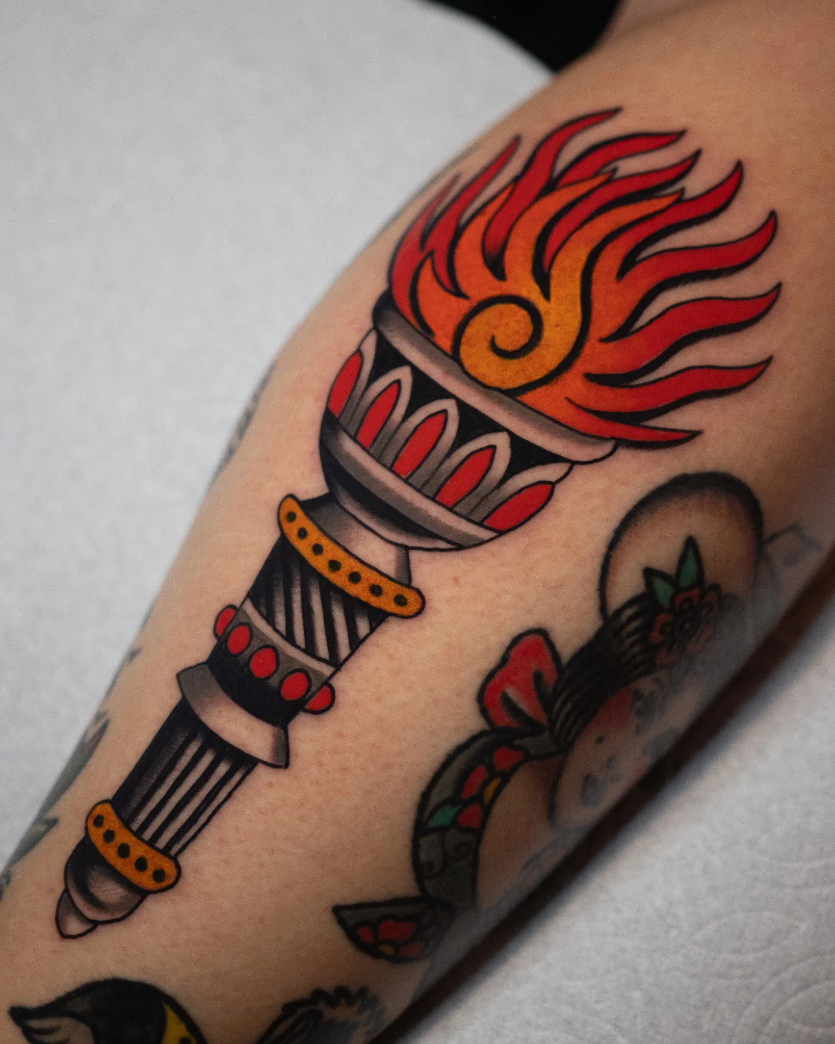 Traditional Torch tattoo in color by Danny Derrick at San Luis Tattoo Company in SLO. Best tattoo shop in San Luis Obispo, CA