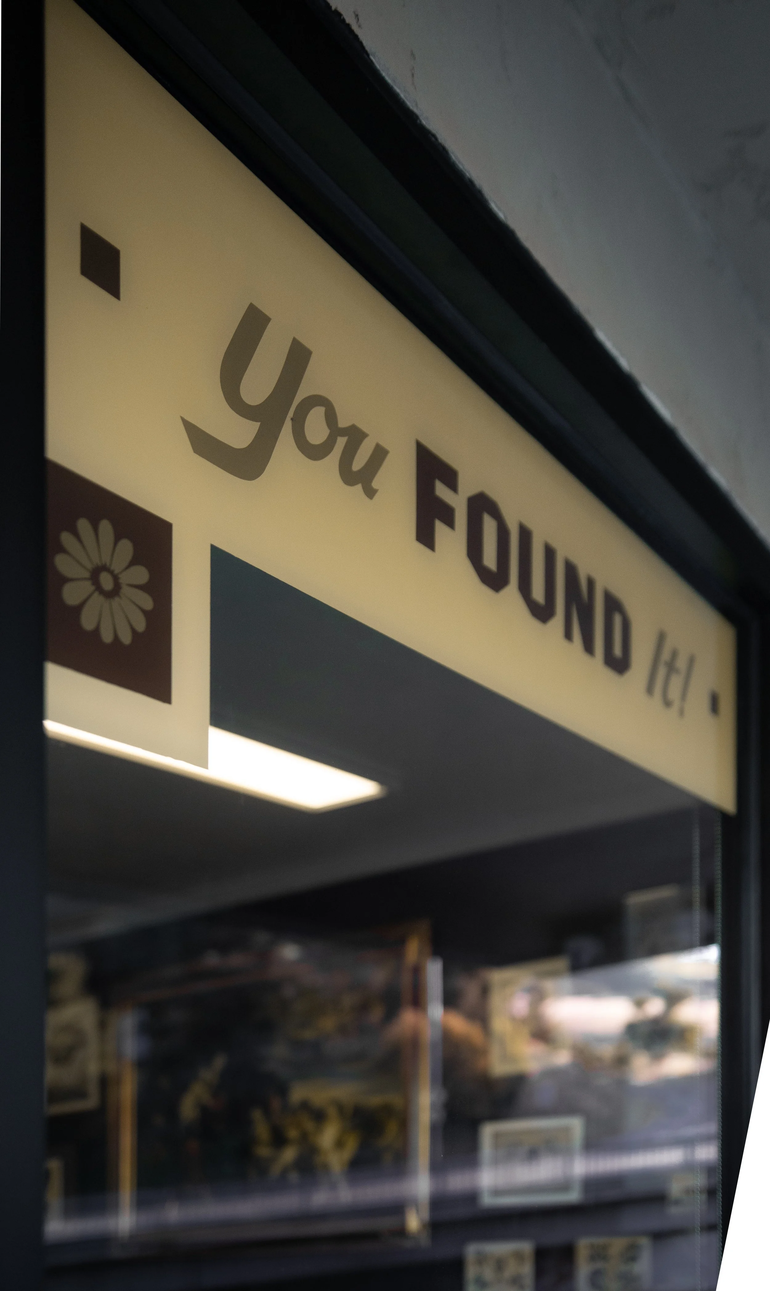 Sign on door that says "You FOND it!" with a flower icon in the bottom left corner. SLO tattoo shop. San Luis Obispo, CA
