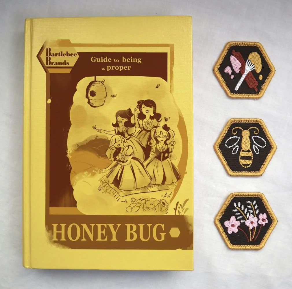   The Bartlebee Brands’ Honey Bug guide book and three badges that sit to the right of it.  
