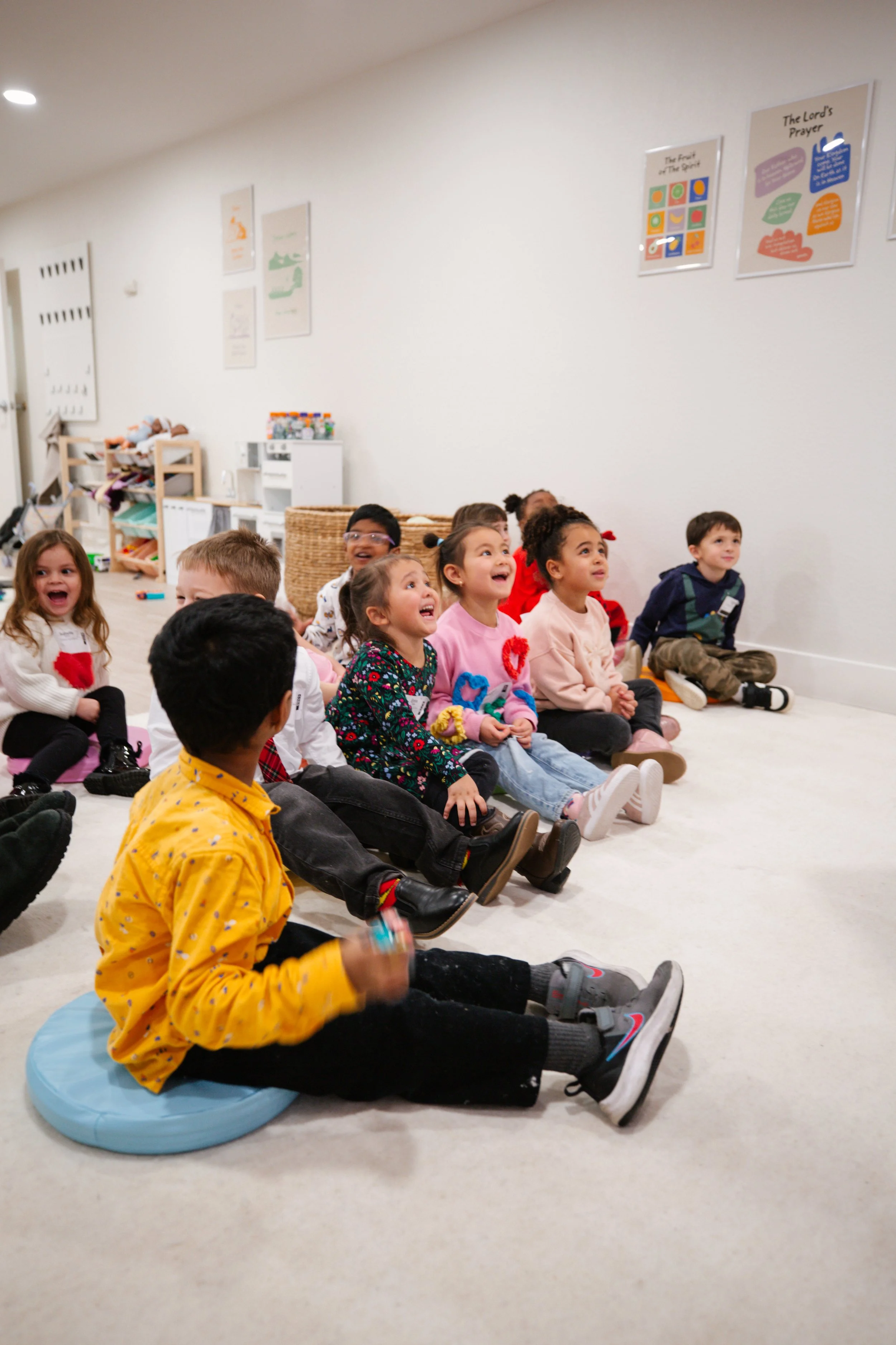 Children playing on a colorful inflatable slide in an outdoor setting.