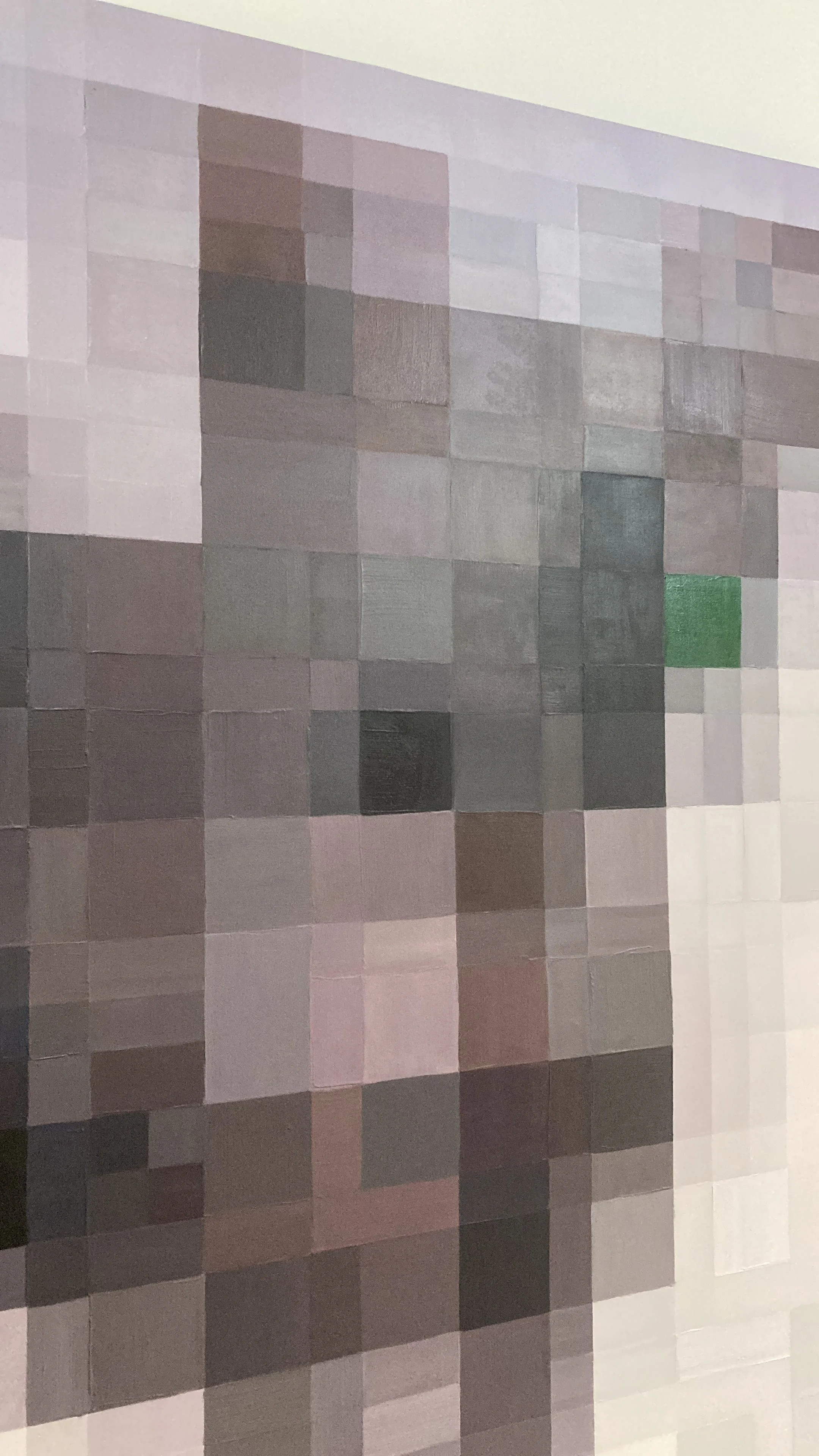 A pixelated image of a person with glasses and a beard, with a mixture of gray, black, and pink tones. There is also some green on the right side.