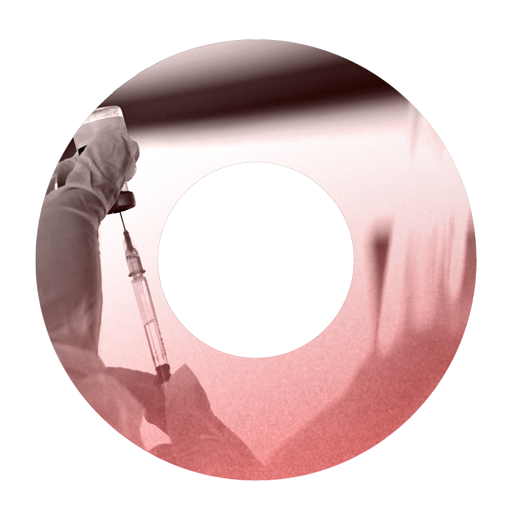 Syringe being filled with liquid in a lab setting, with microscopic view of cells in red tint.