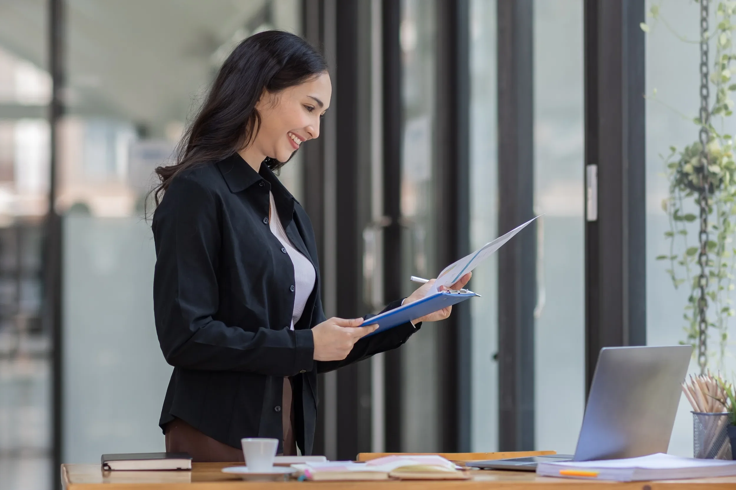 Business leader reviewing strategic documents in a modern office, representing preventive medicine as a long-term performance investment
