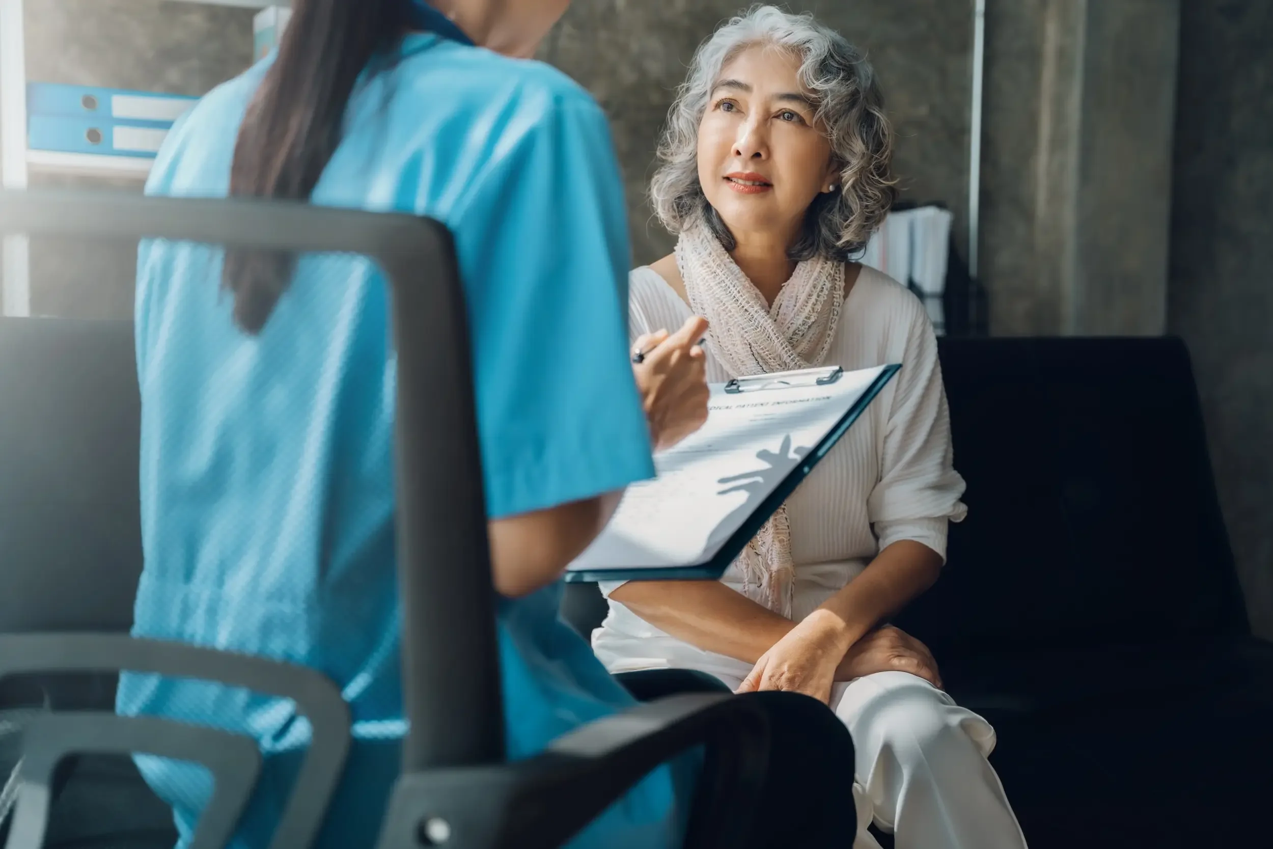 Female doctor counseling a female senior patient.