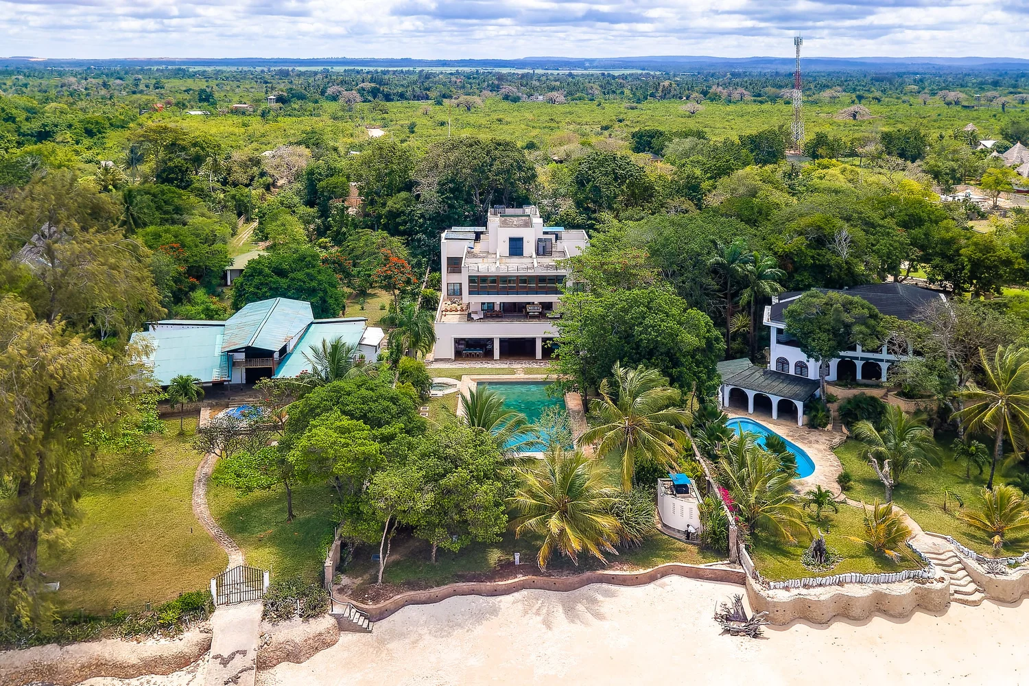 Aerial view of Cocokinondo surrounded by tropical gardens on the beachfront
