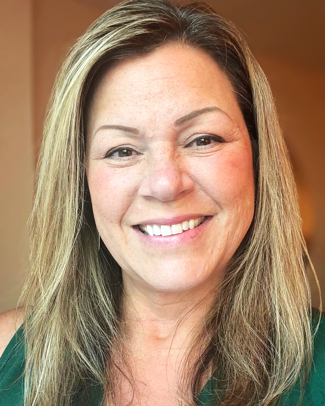 Cori Woolf professional headshot, woman smiling in green blouse