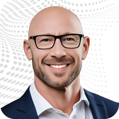 A smiling man with glasses, wearing a dark suit and white shirt, against a patterned background.