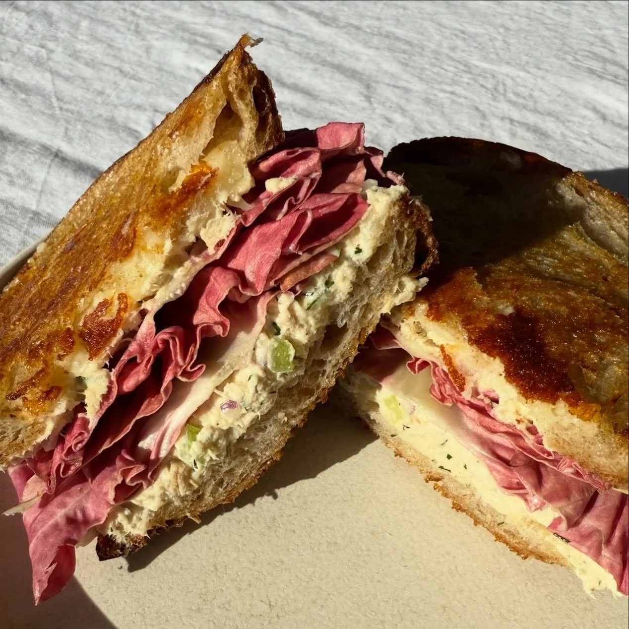 Friday calls for a home-made tuna melt with some of our favorites in store! 🤍

Ingredient list: 
@61hundredbread sliced sourdough bread
Tuna salad 
Cheddar blend 
Kerrygold butter

How we do it: 
Cook it low and covered so everything melts evenly wi