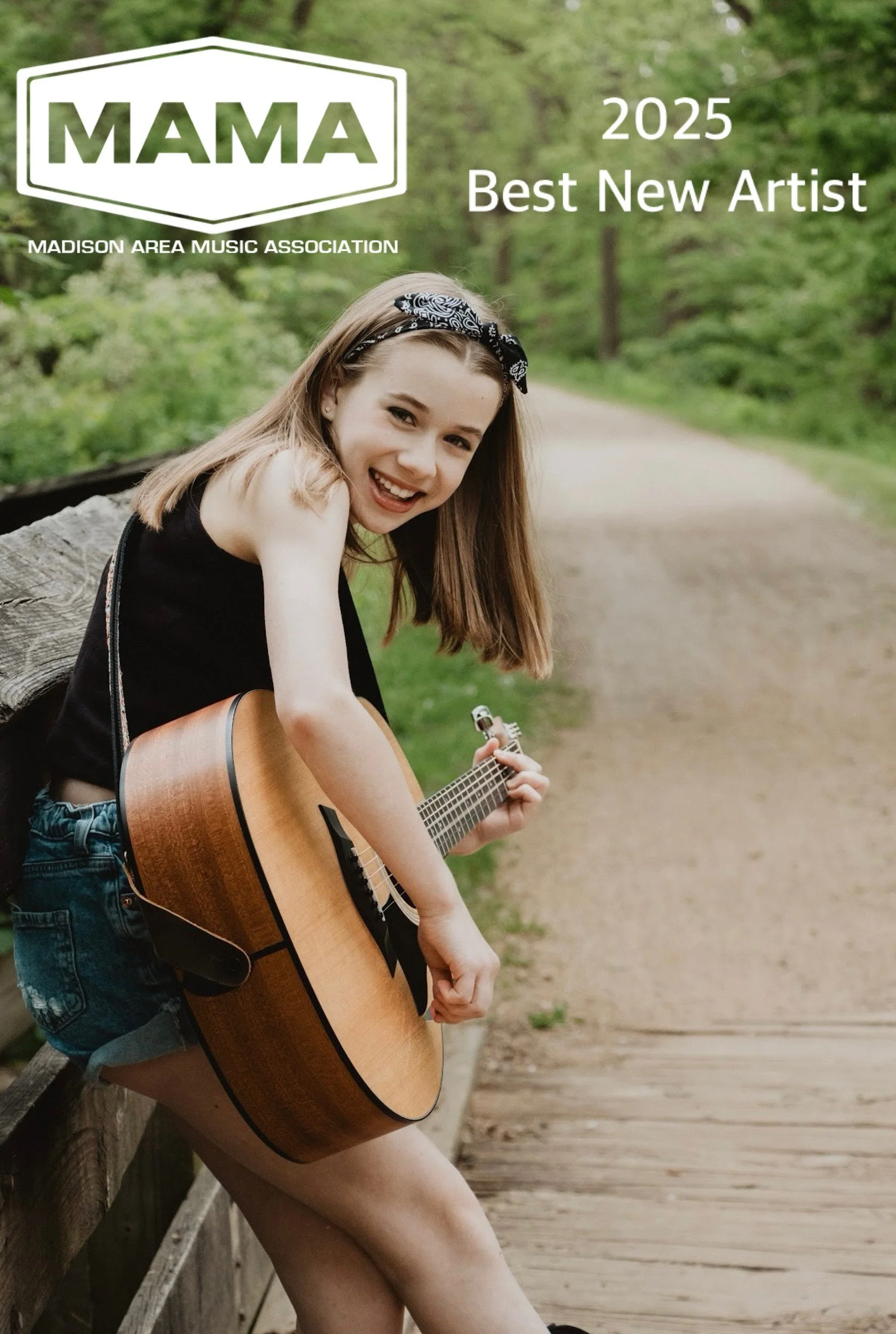 A young woman with long hair and a bandana playing an acoustic guitar outdoors on a bridge surrounded by greenery with text and logos indicating she is the 2025 Madison Area Music Association Best New Artist award winner.