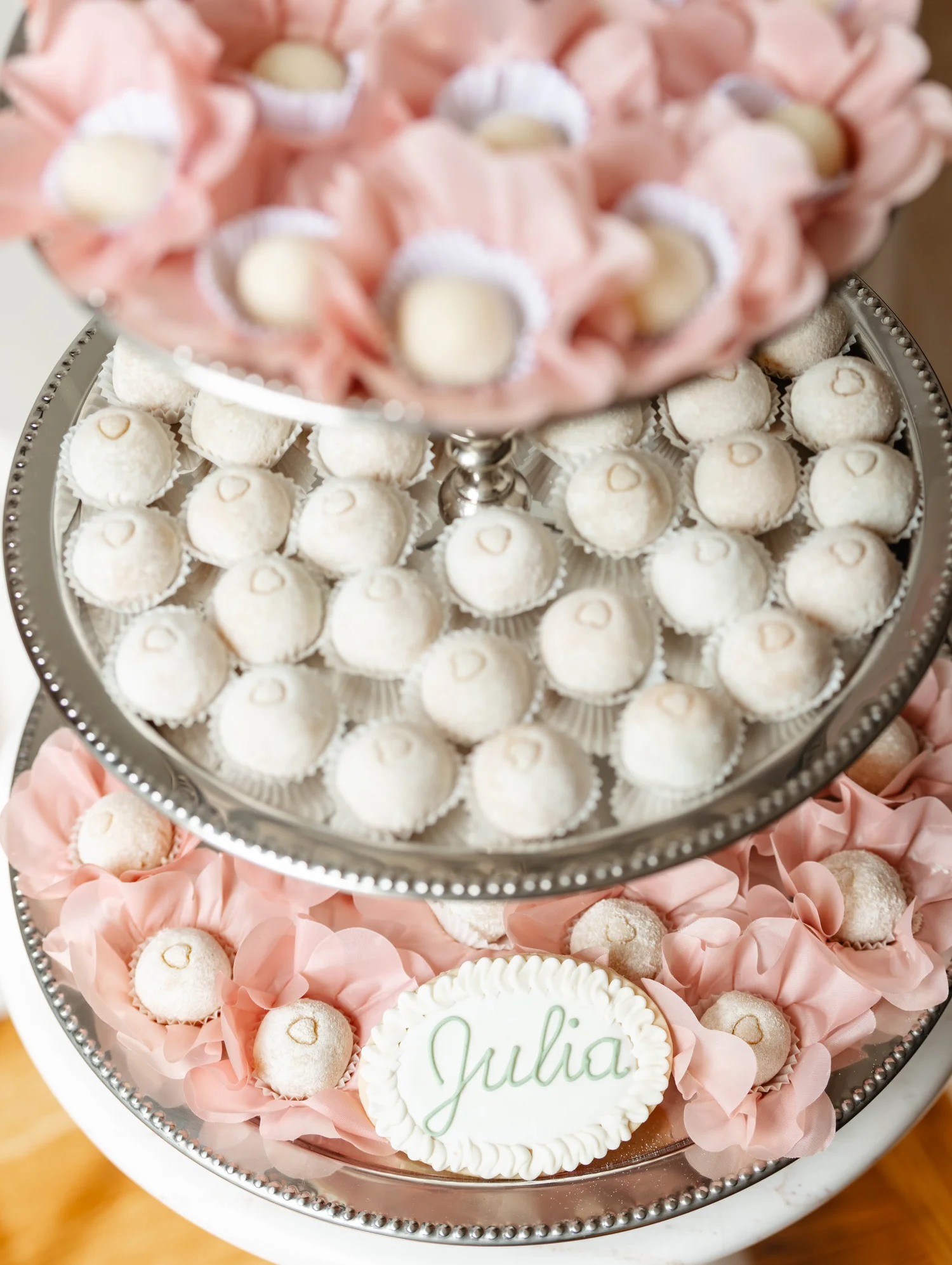 Tiered baby shower sweets display with pink floral details and a personalized Julia cookie