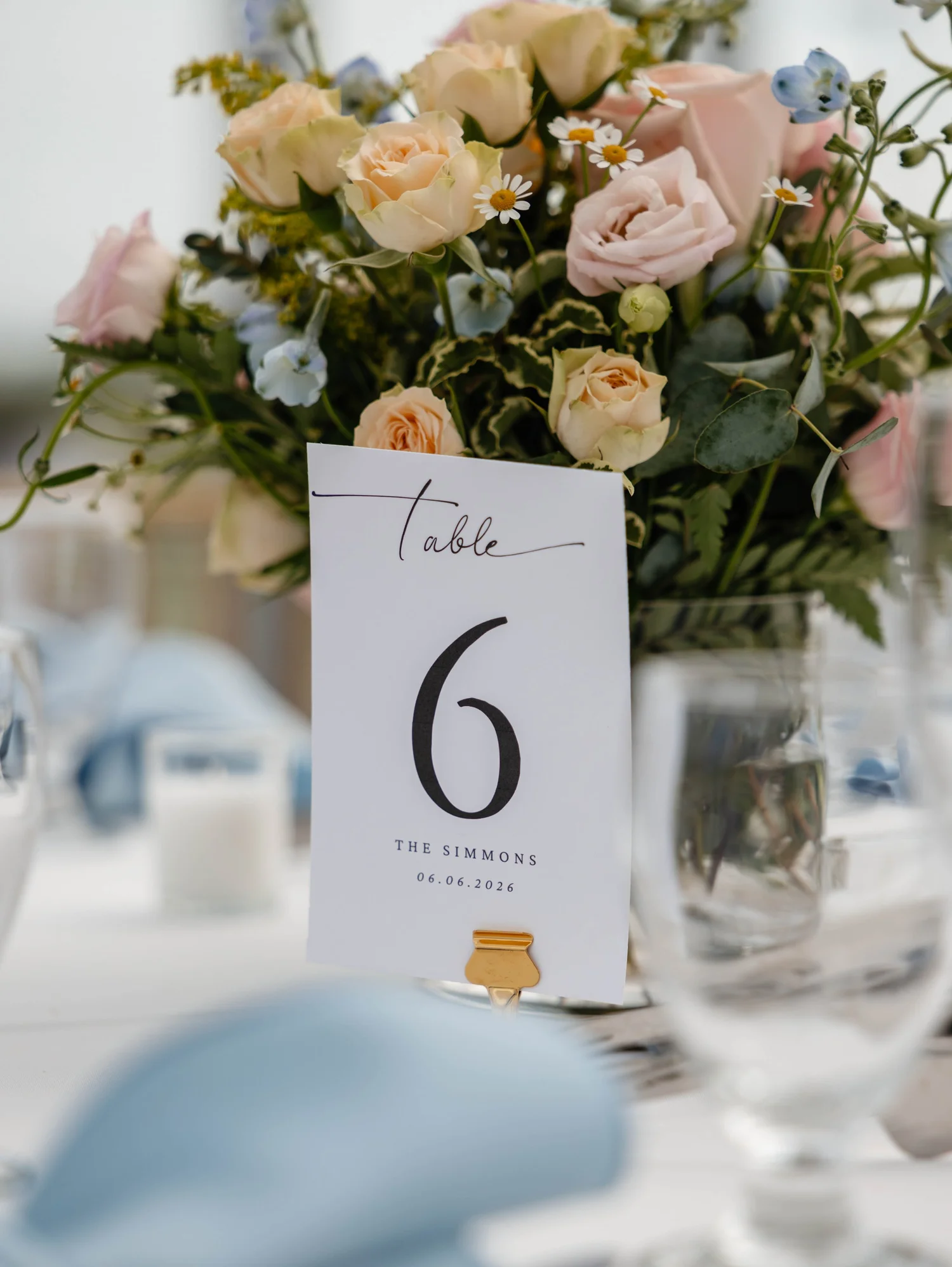 Wedding table number framed by pastel garden flowers