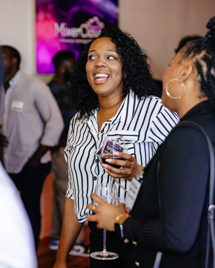 Smiling attendees talking at a networking gathering