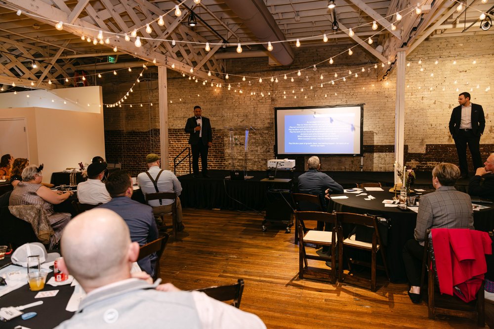Corporate event audience listening to an on-stage speaker