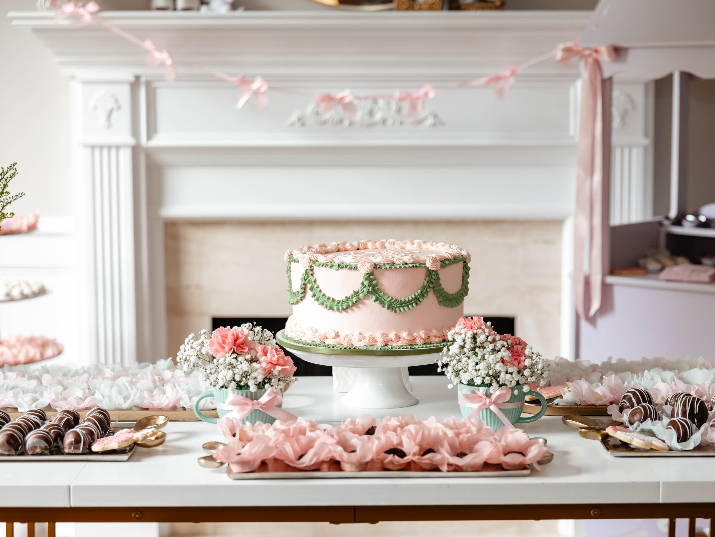 Baby shower dessert table styled in pink, green and white