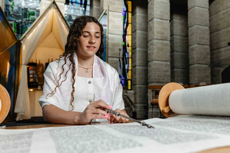 Lexie reading from the Torah during her Bat Mitzvah