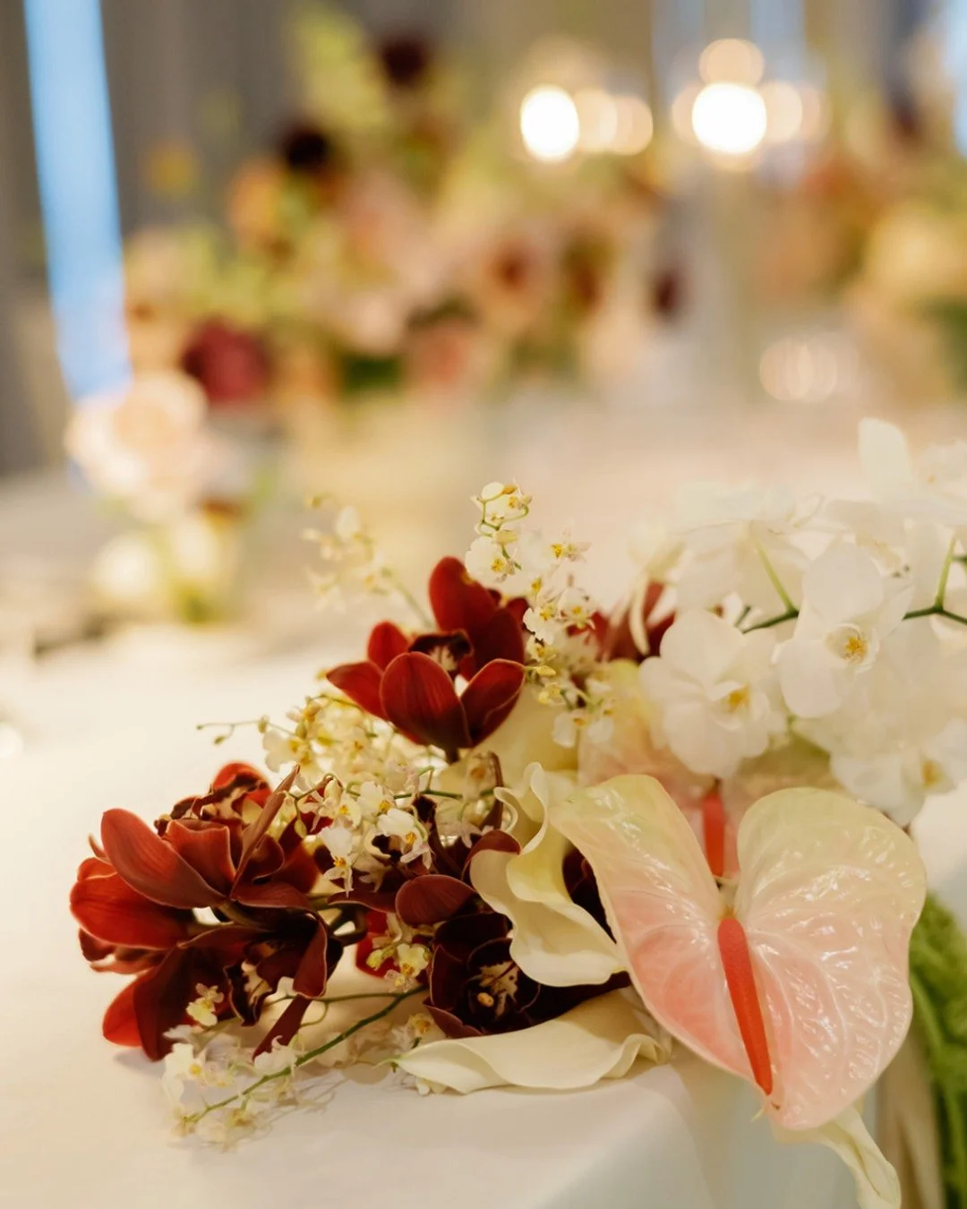Your guests will forget the menu.
They will forget the centerpiece color.
They will never forget how the room made them feel.

Florals don't decorate a wedding.
They set the emotional temperature of the entire day.

Every arrangement we design starts