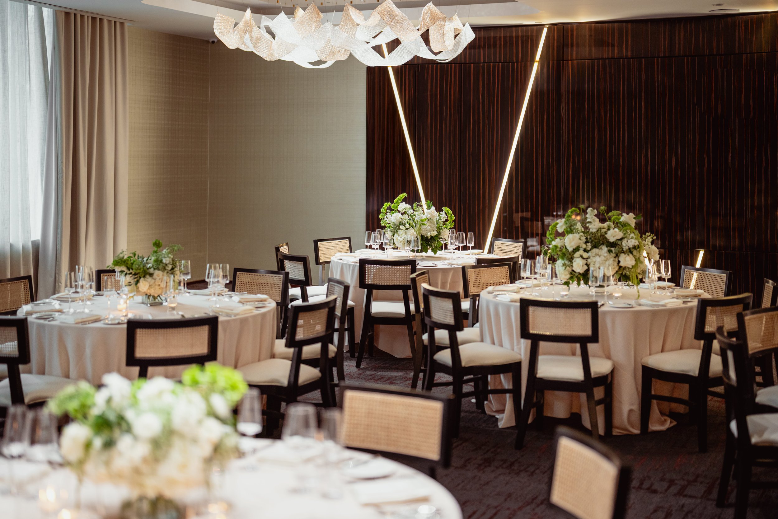 Soleil dining room with round tables and florals