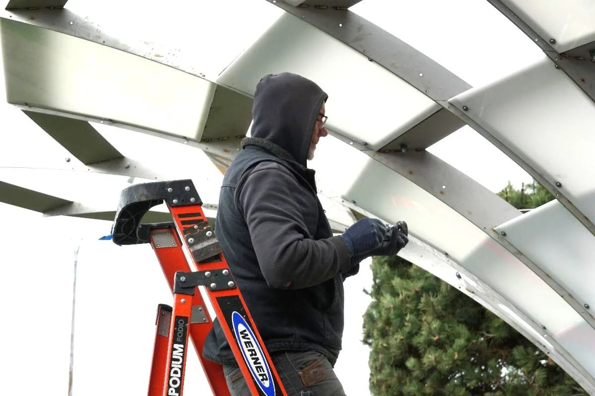 installing the white polycarbonate panels.