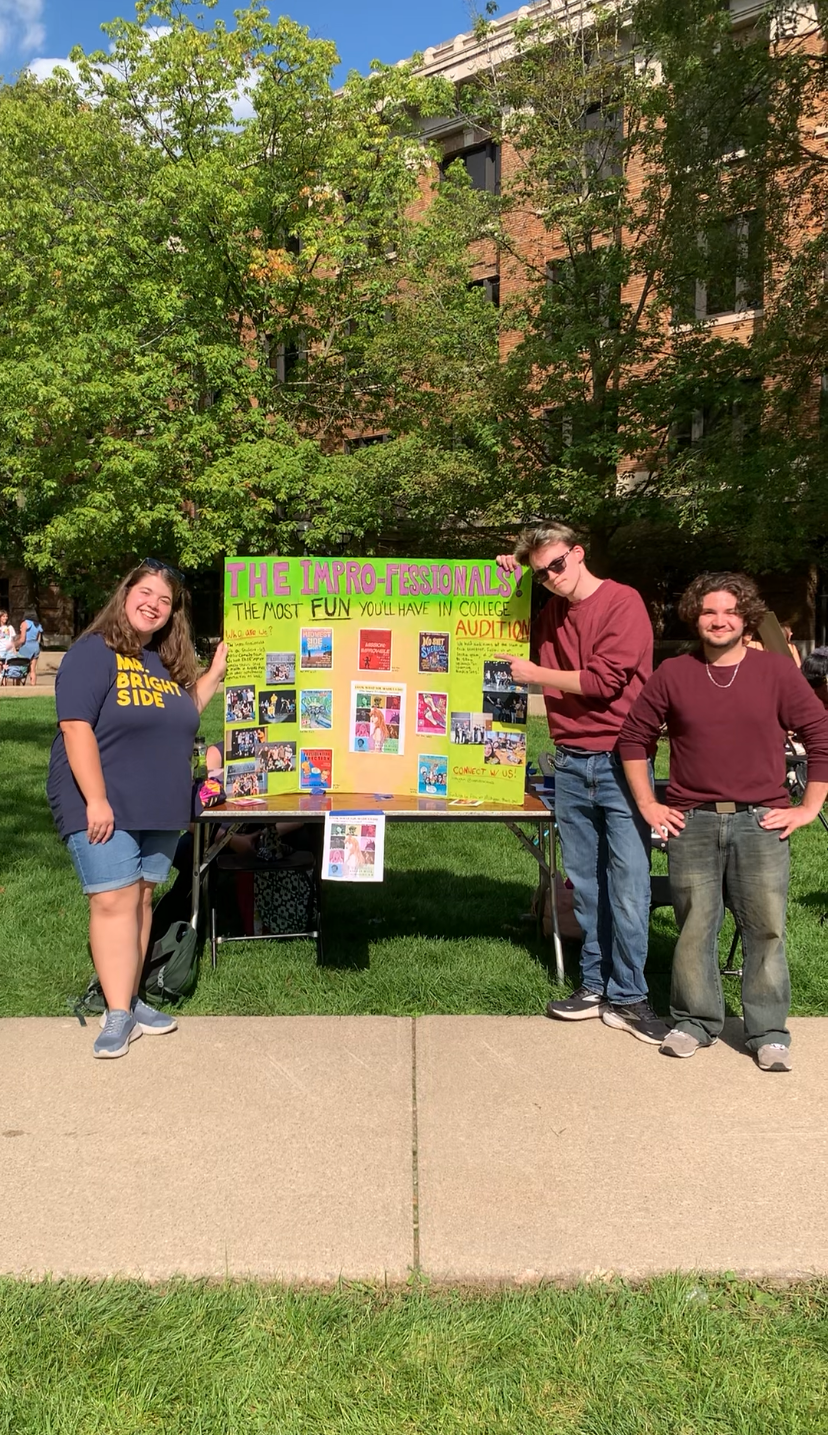 students from the impro-fessionals with poster