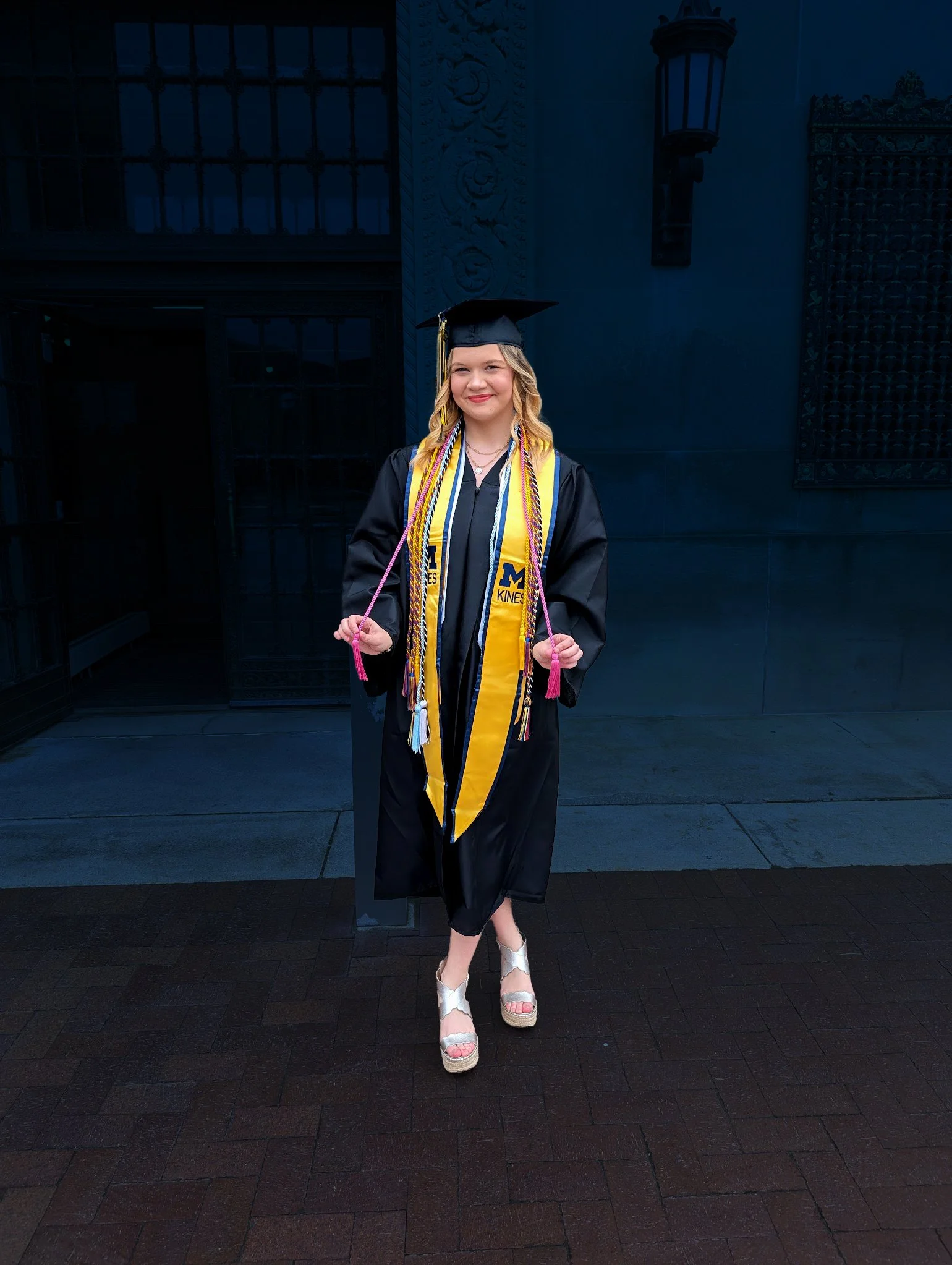 A 2025 graduate of the University of Michigan with arts honors cords