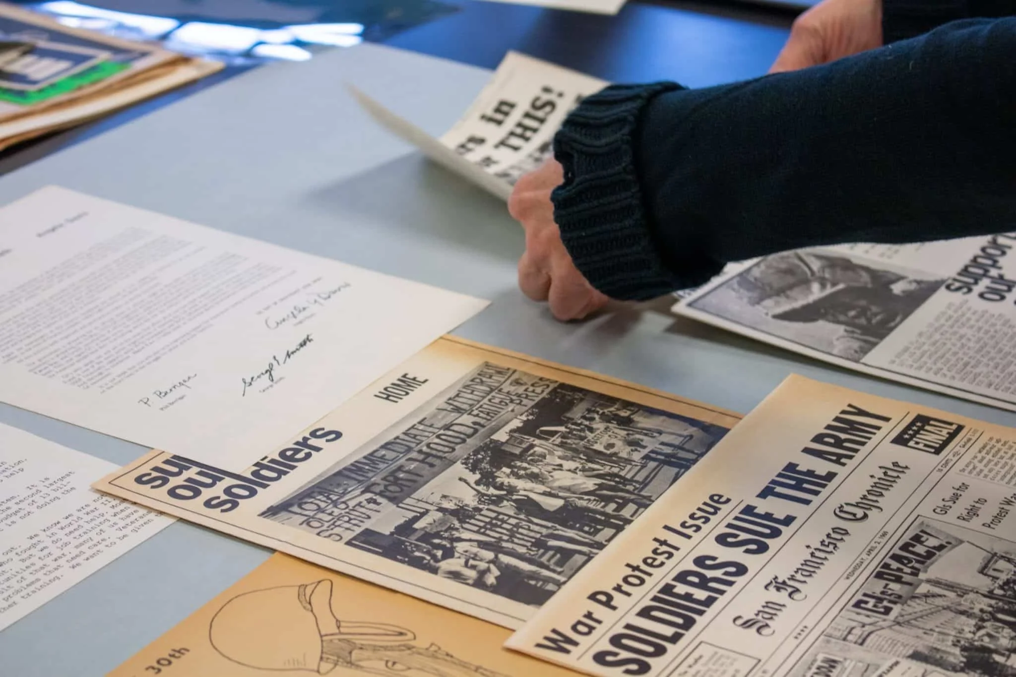 Julie Ault reviews materials from the Labadie Collection. Courtesy of the University of Michigan Museum of Art