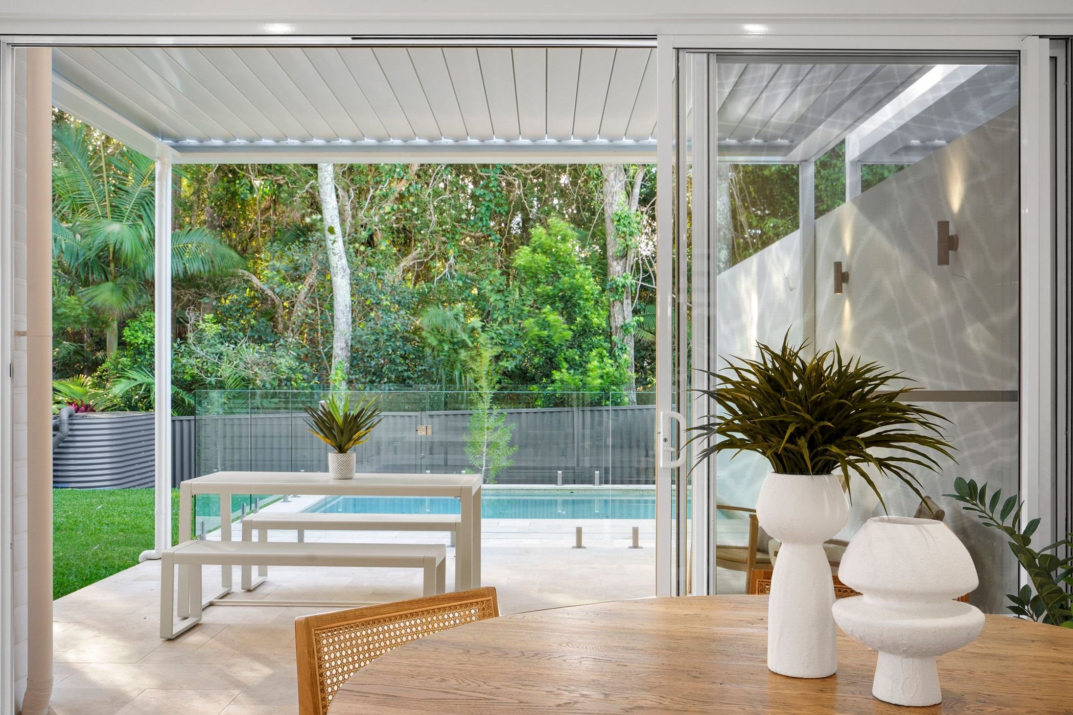 Custom designed duplex project in Port Macquarie features swimming pool with glass fencing and outdoor undercover entertaining area.