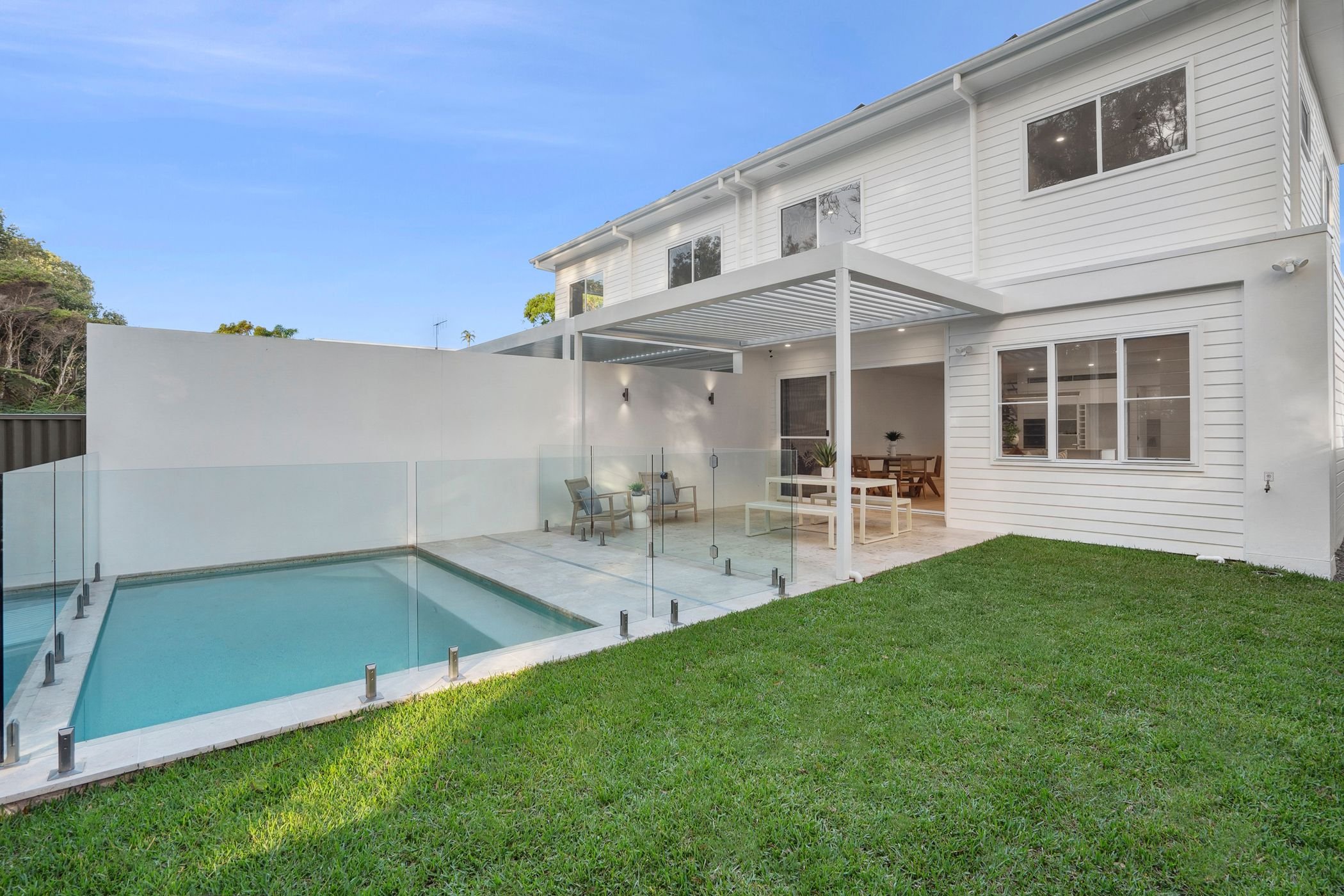 Boutique duplex project in Port Macquarie features swimming pool with glass fencing and outdoor undercover entertaining area.