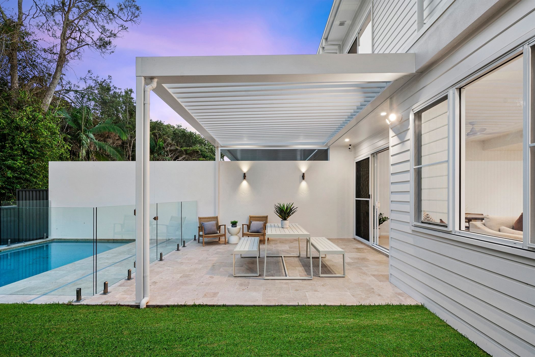 Custom designed duplex project in Port Macquarie features swimming pool with glass fencing and outdoor undercover entertaining area.