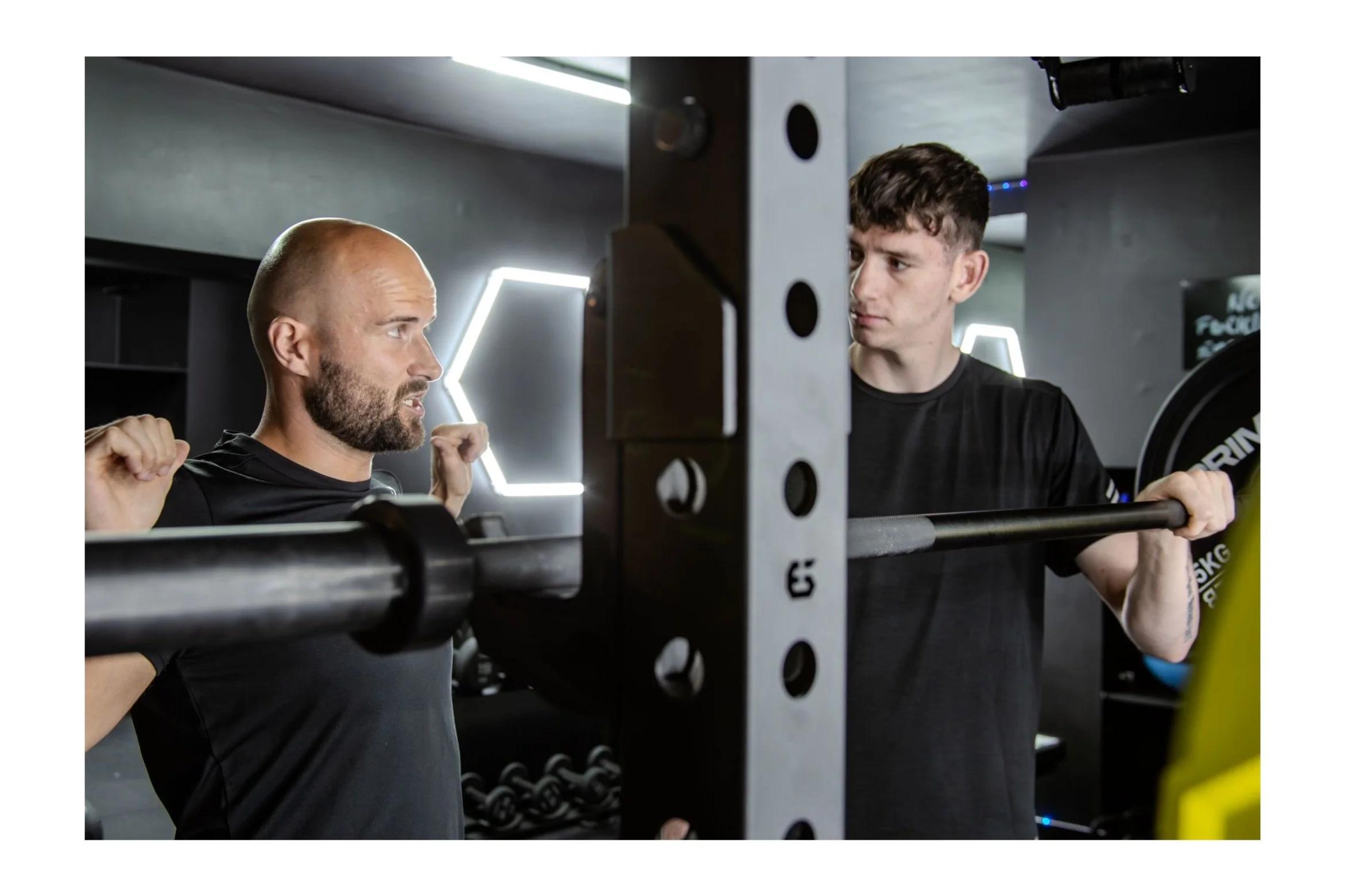 Strength and Conditioning Coach explaining how to set up a back squat